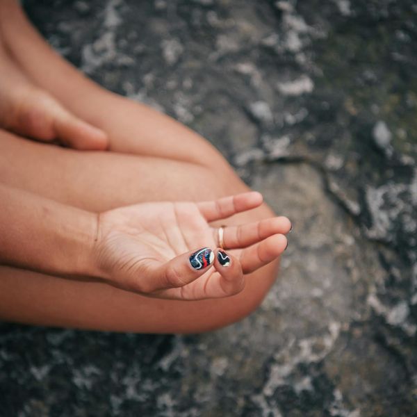 Close up of a person hands in a meditative mudra position