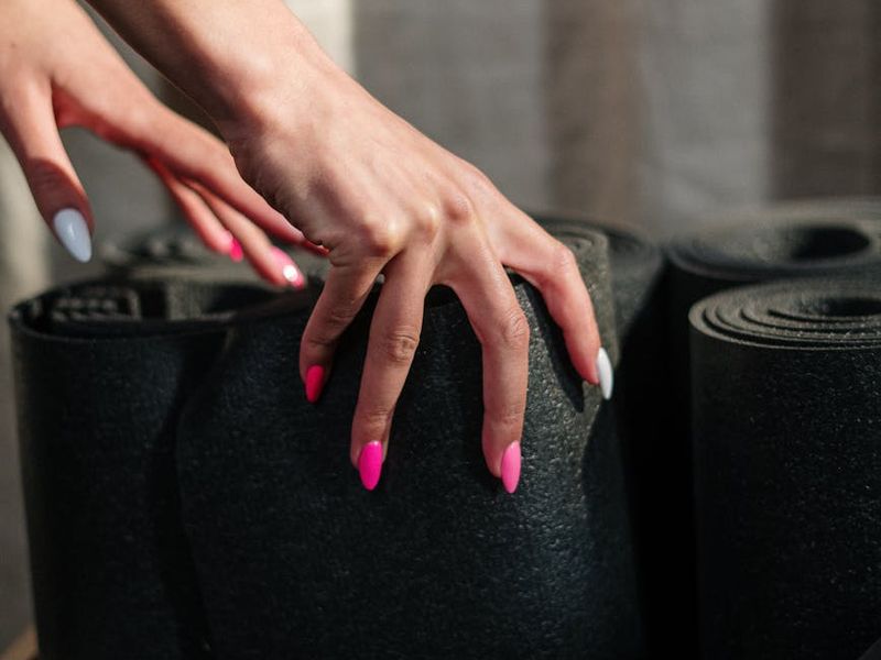 Detailed close-up of yoga mat and hands during a flow session